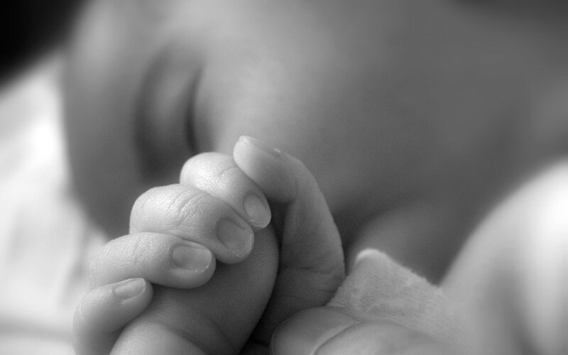 Baby's hands clasped in sleep
