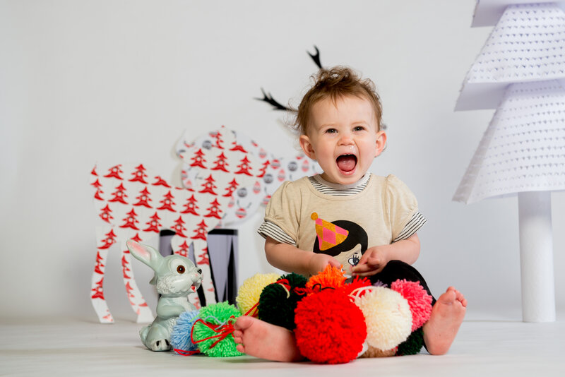 Baby Sitting on Floor — White, Playful