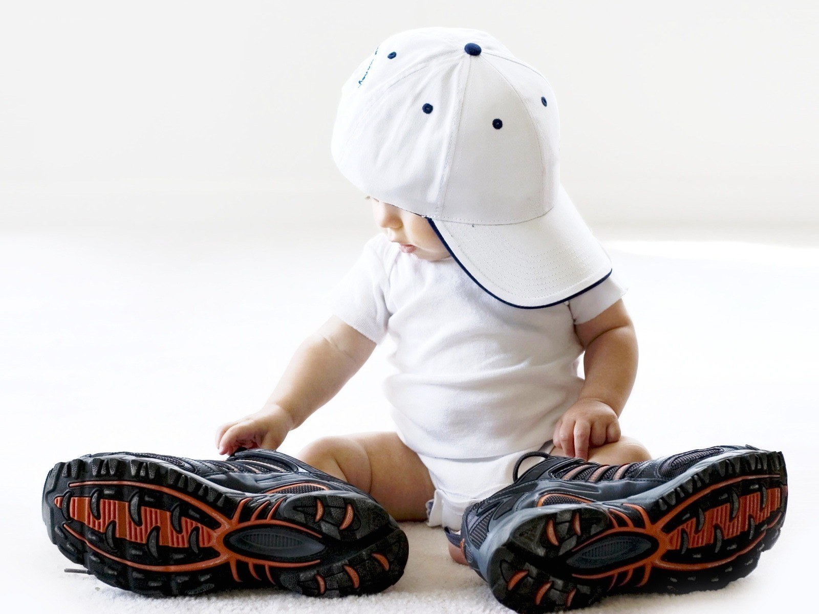 Baby sitting with sneakers