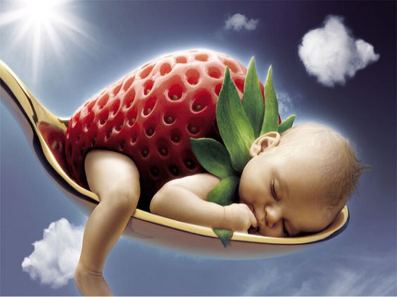 Baby sleeping in a strawberry spoon