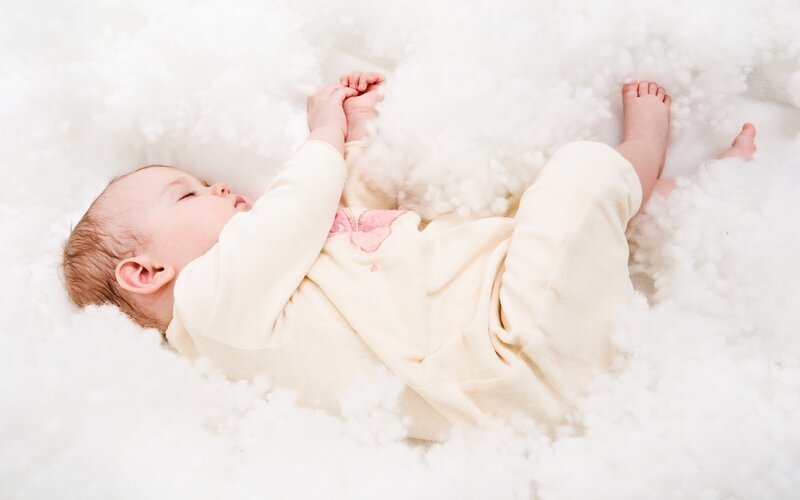 Baby sleeping in cotton fluff