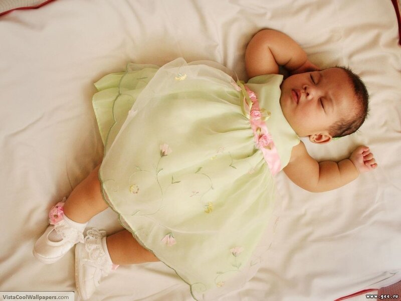 Baby sleeping in green dress