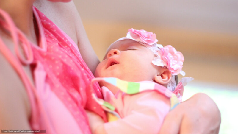 Baby sleeping in mother's arms