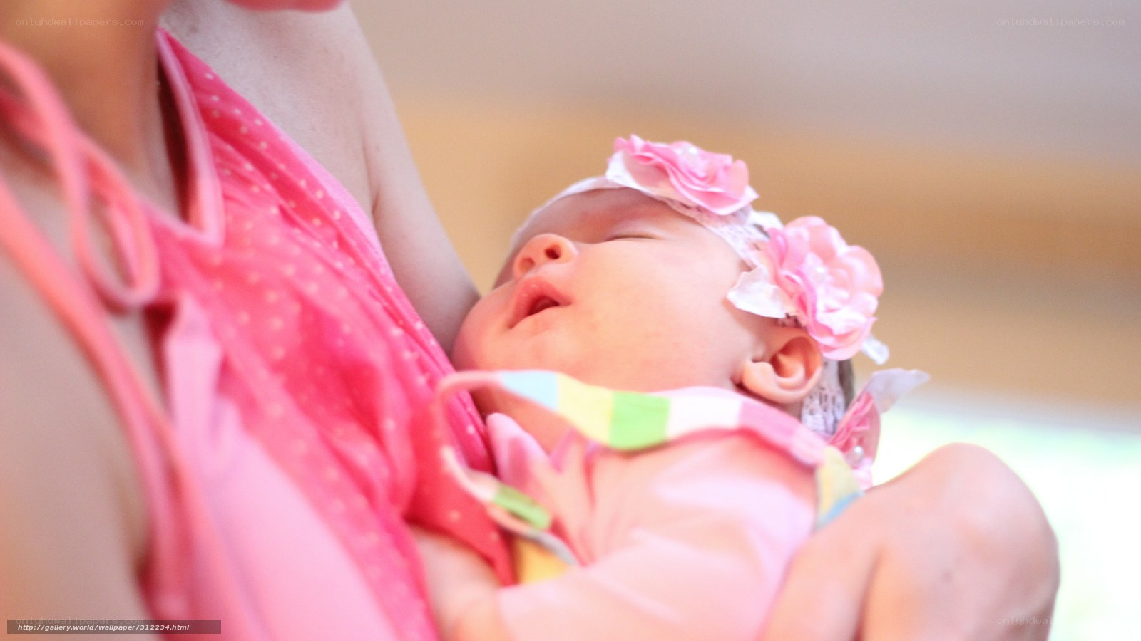 Baby sleeping in mother's arms