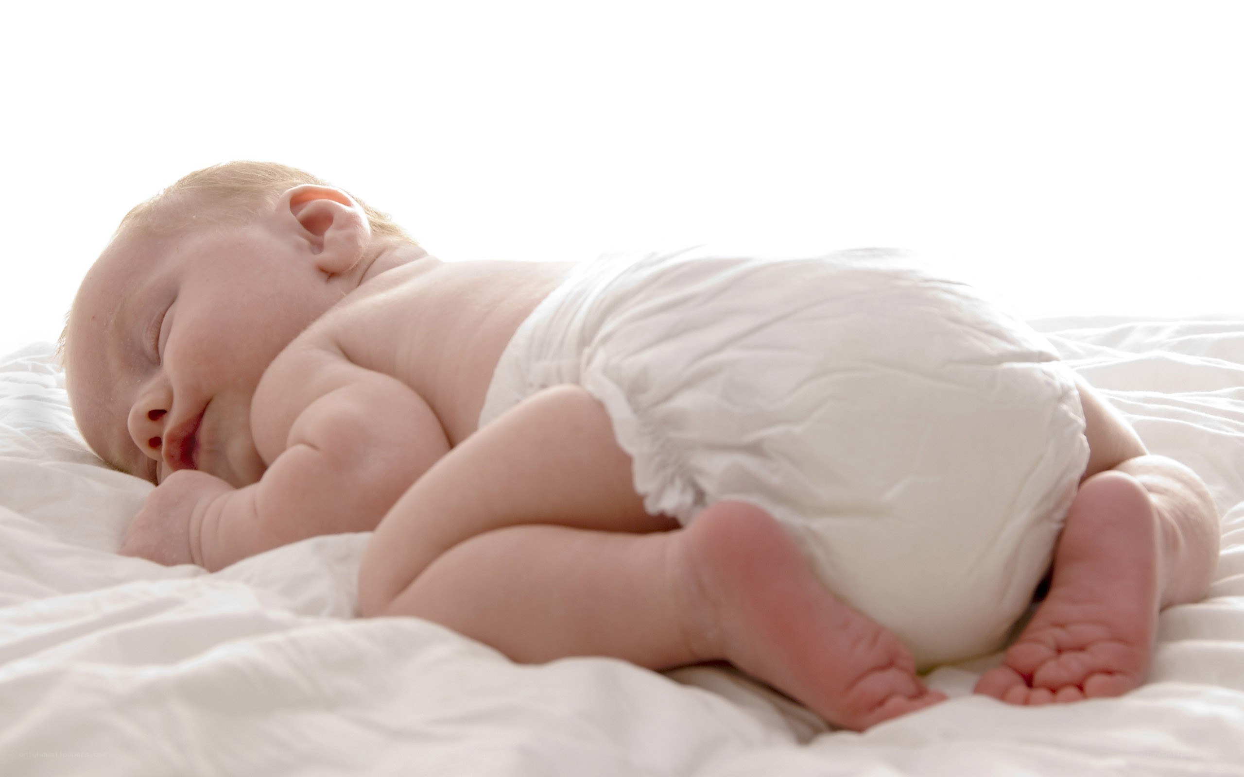 Baby sleeping on white bed