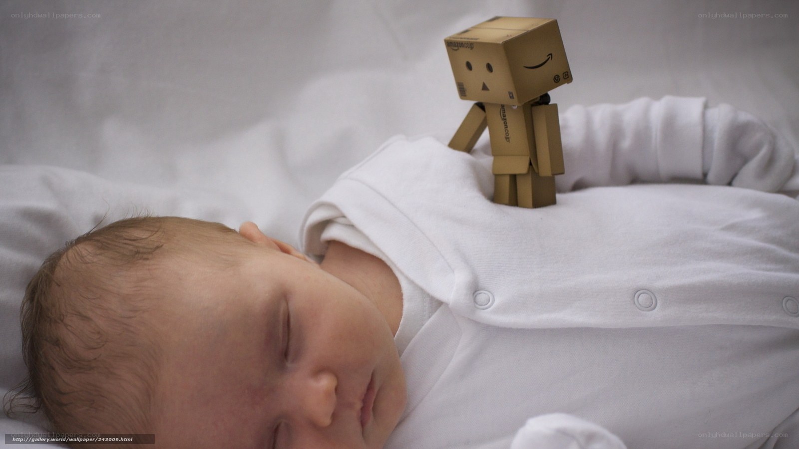 Baby sleeping with cardboard robot