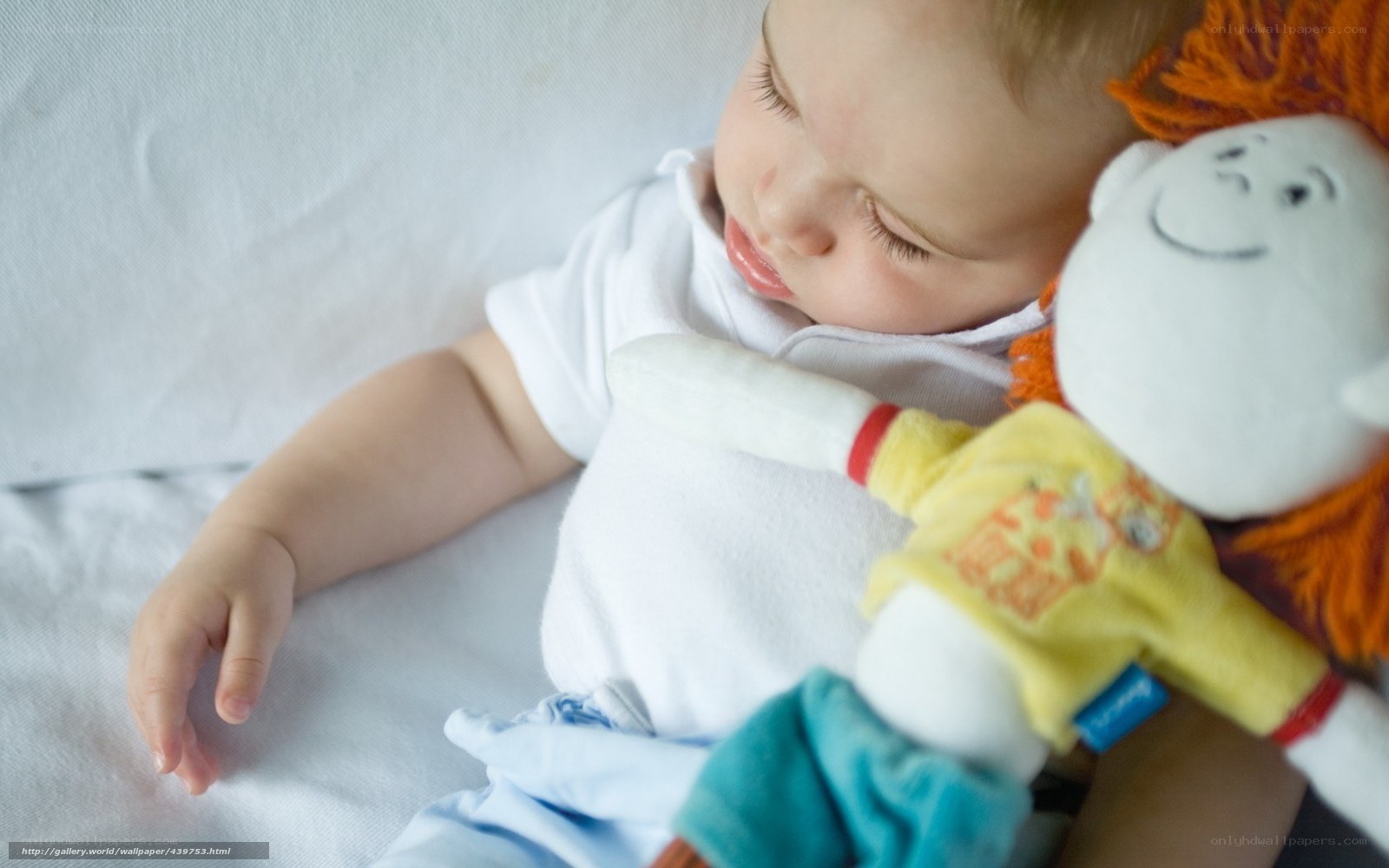 Baby sleeping with doll