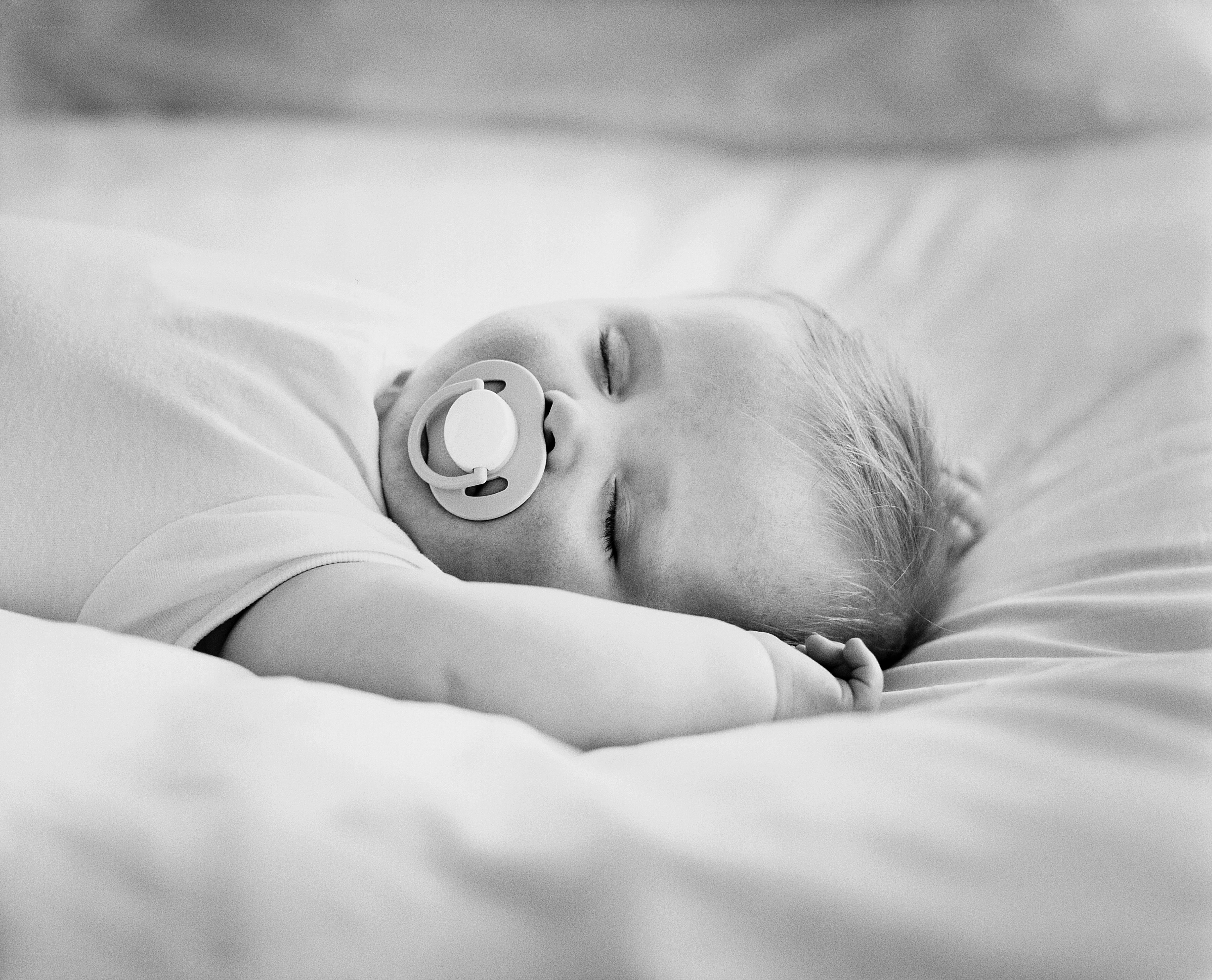 Baby sleeping with pacifier