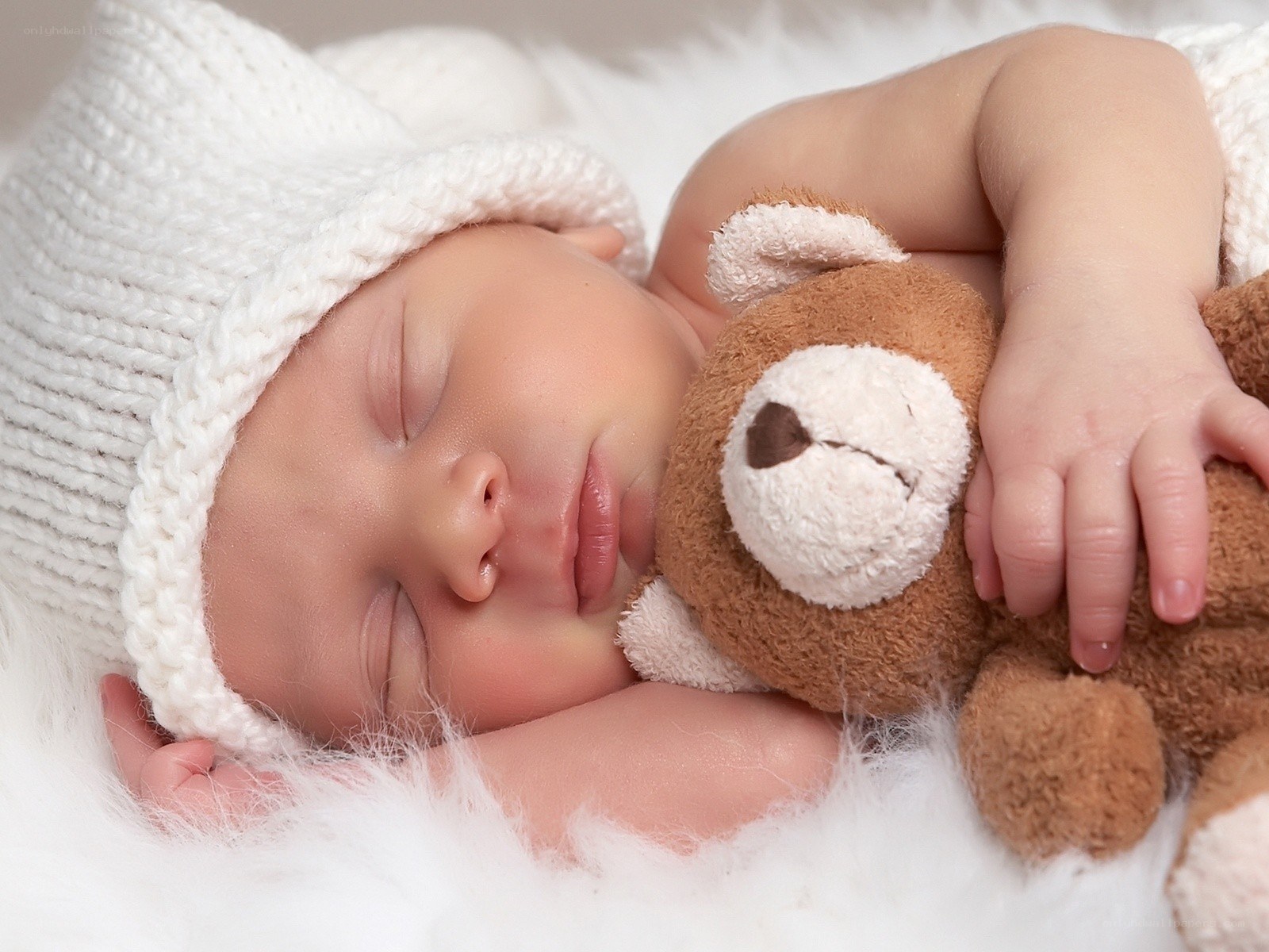 Baby sleeping with teddy bear