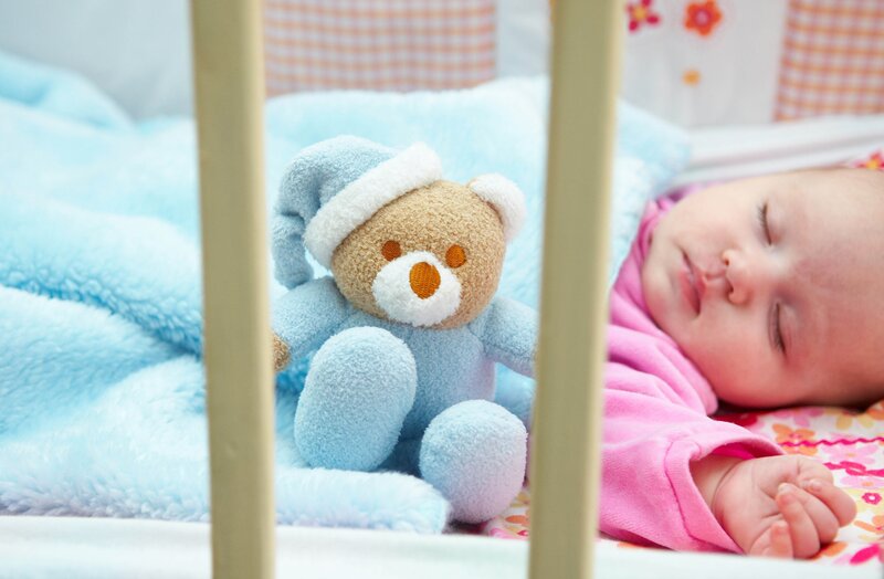 Baby sleeping with teddy bear
