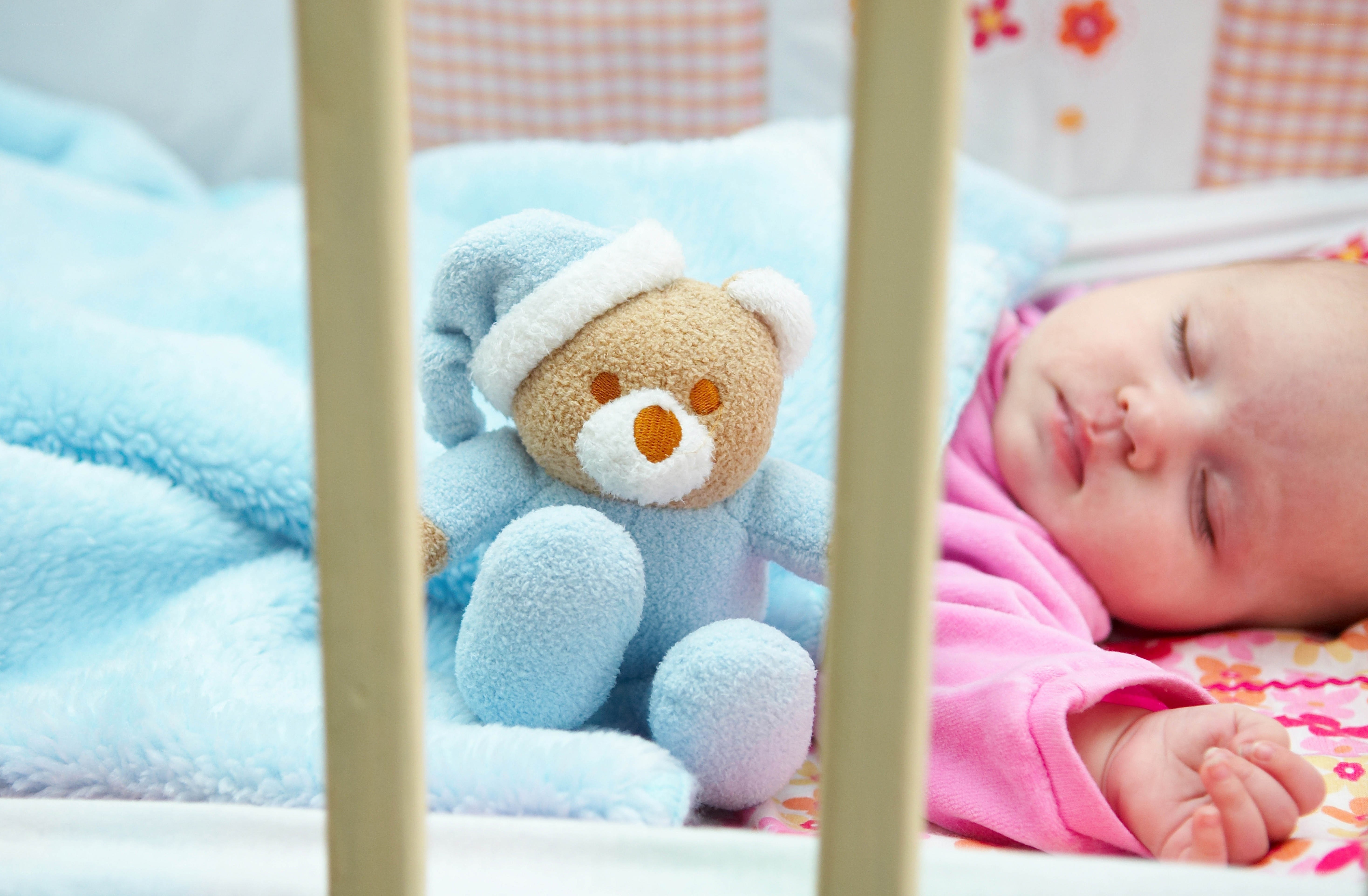 Baby sleeping with teddy bear