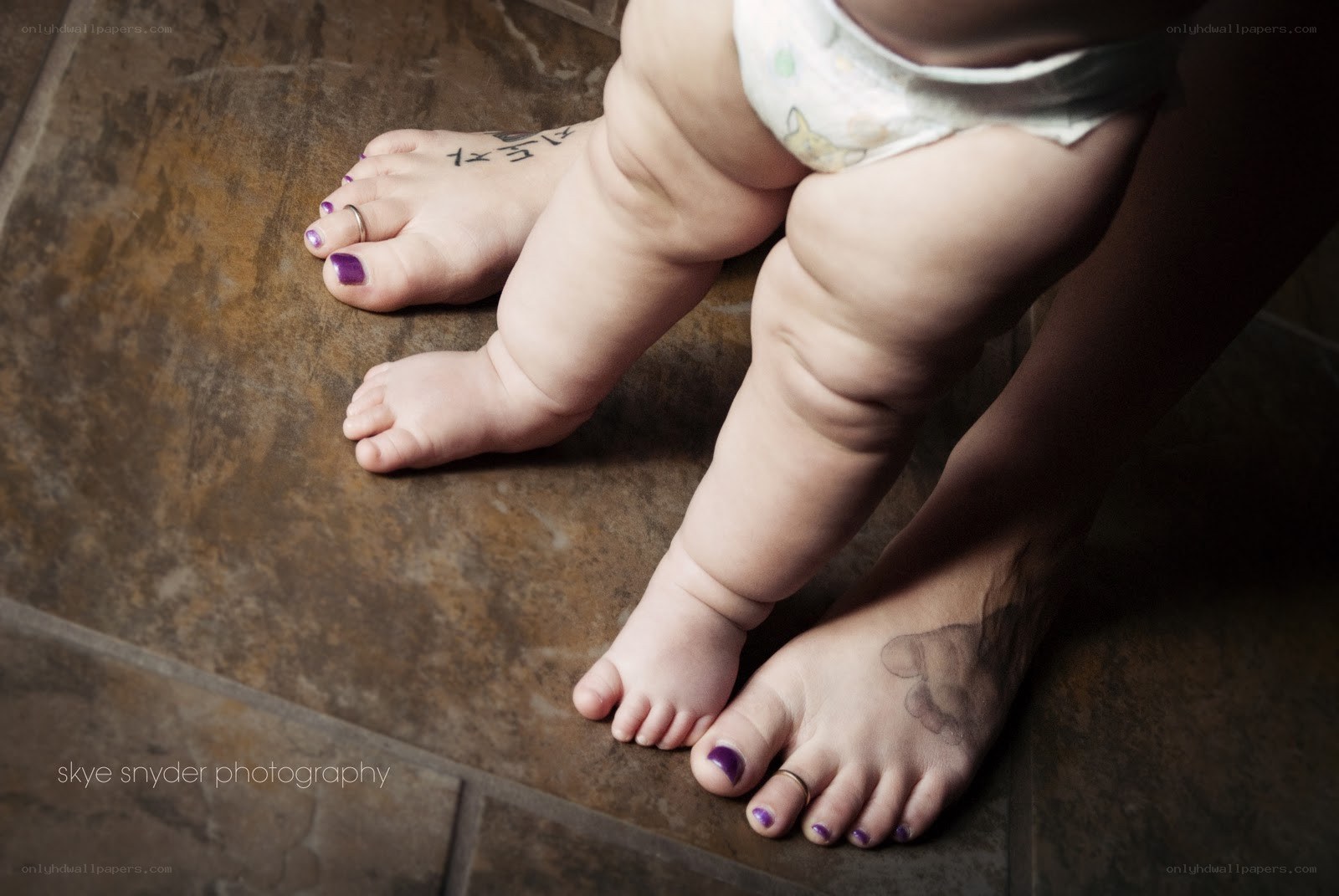 Baby standing on tiled floor