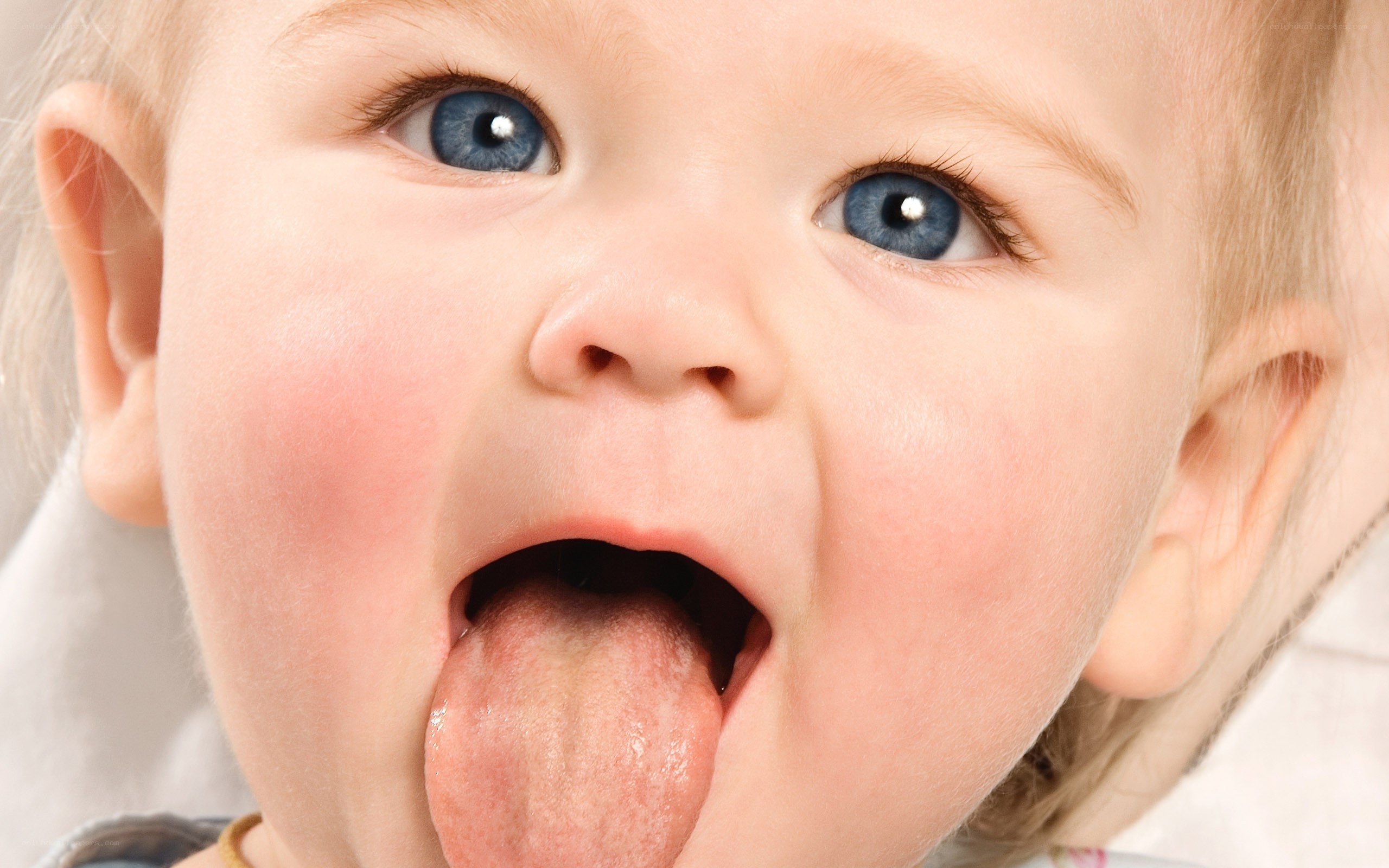 baby sticking out tongue