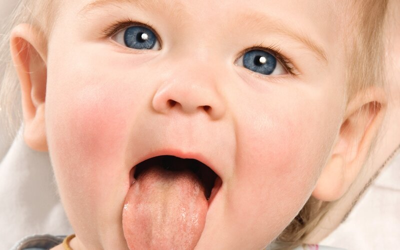 baby sticking out tongue