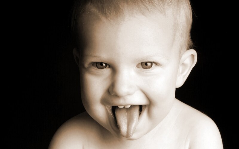 Baby Sticking Out Tongue — Sepia