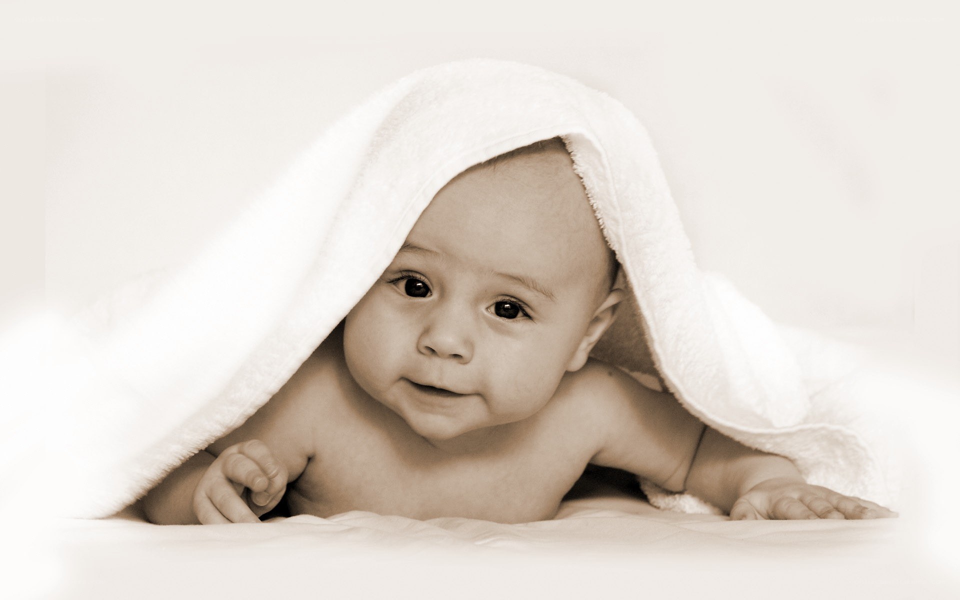 baby under towel blanket