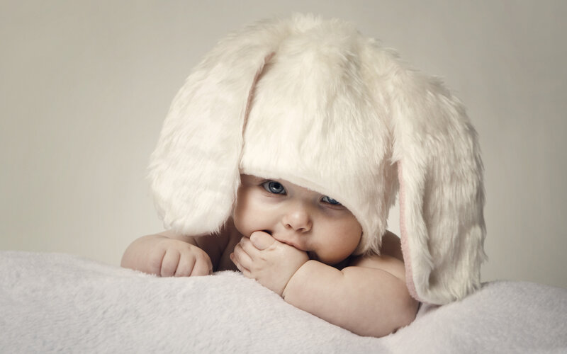 Baby Wearing Bunny Hat — White, Calm