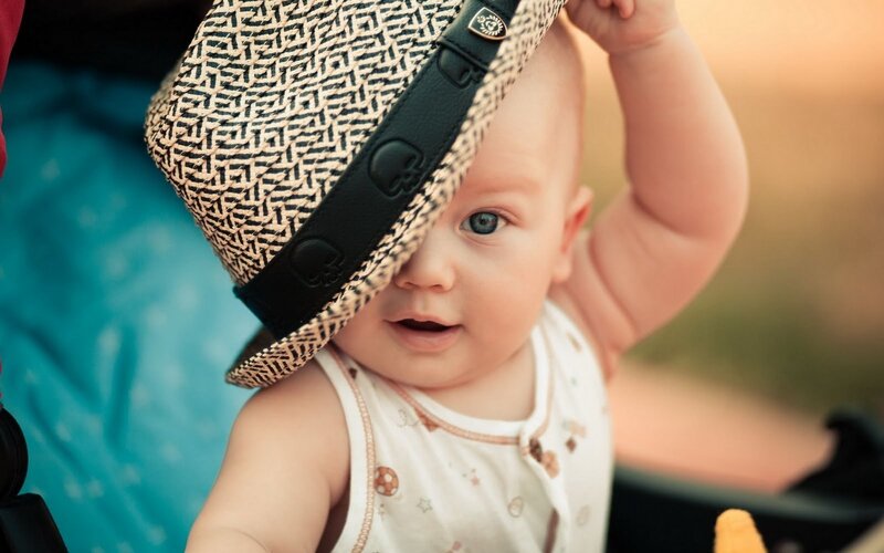 Baby Wearing Hat — White, Calm, Sunset