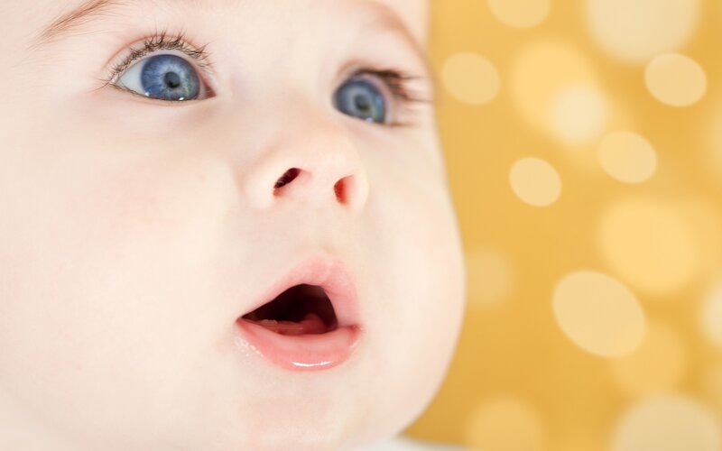 baby with blue eyes looking up
