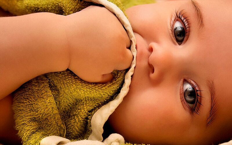 baby with green blanket
