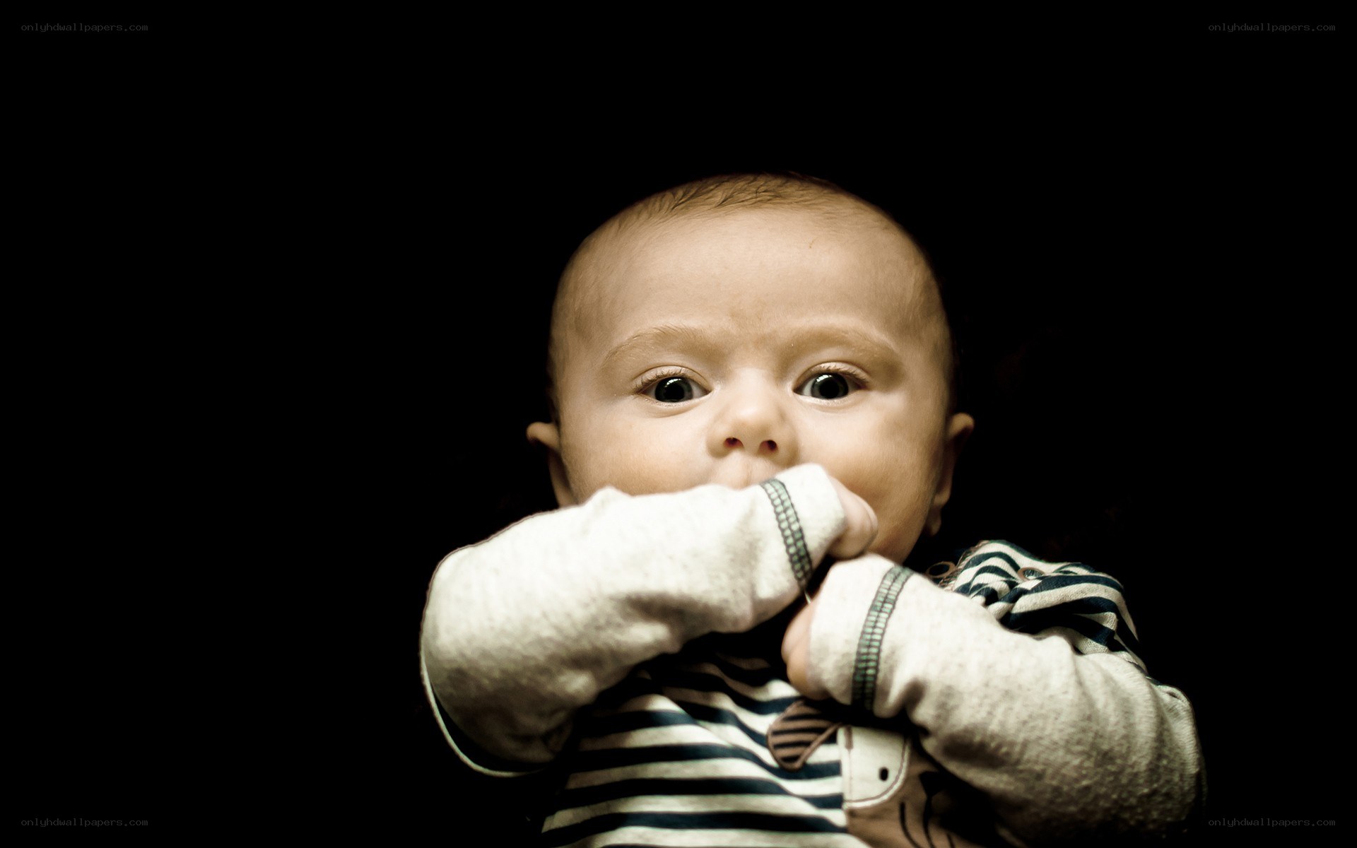 baby with hands in mouth