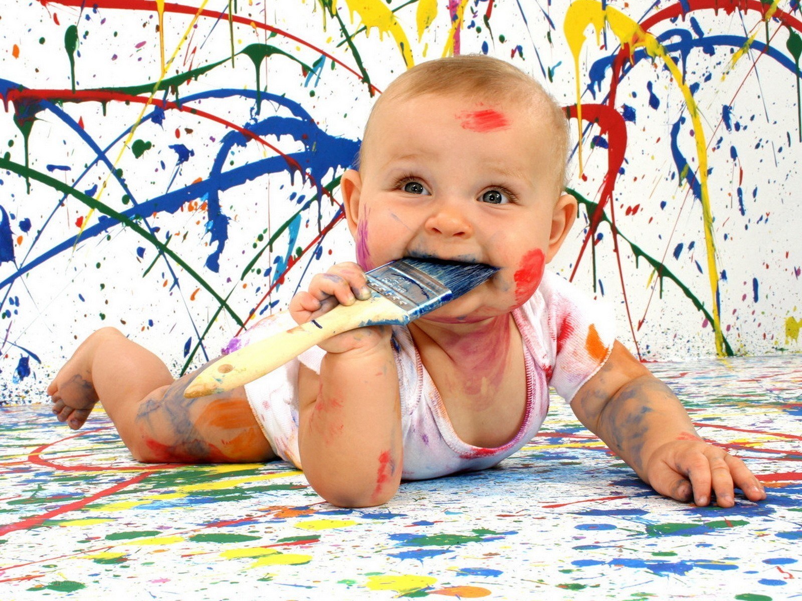 baby with paintbrush