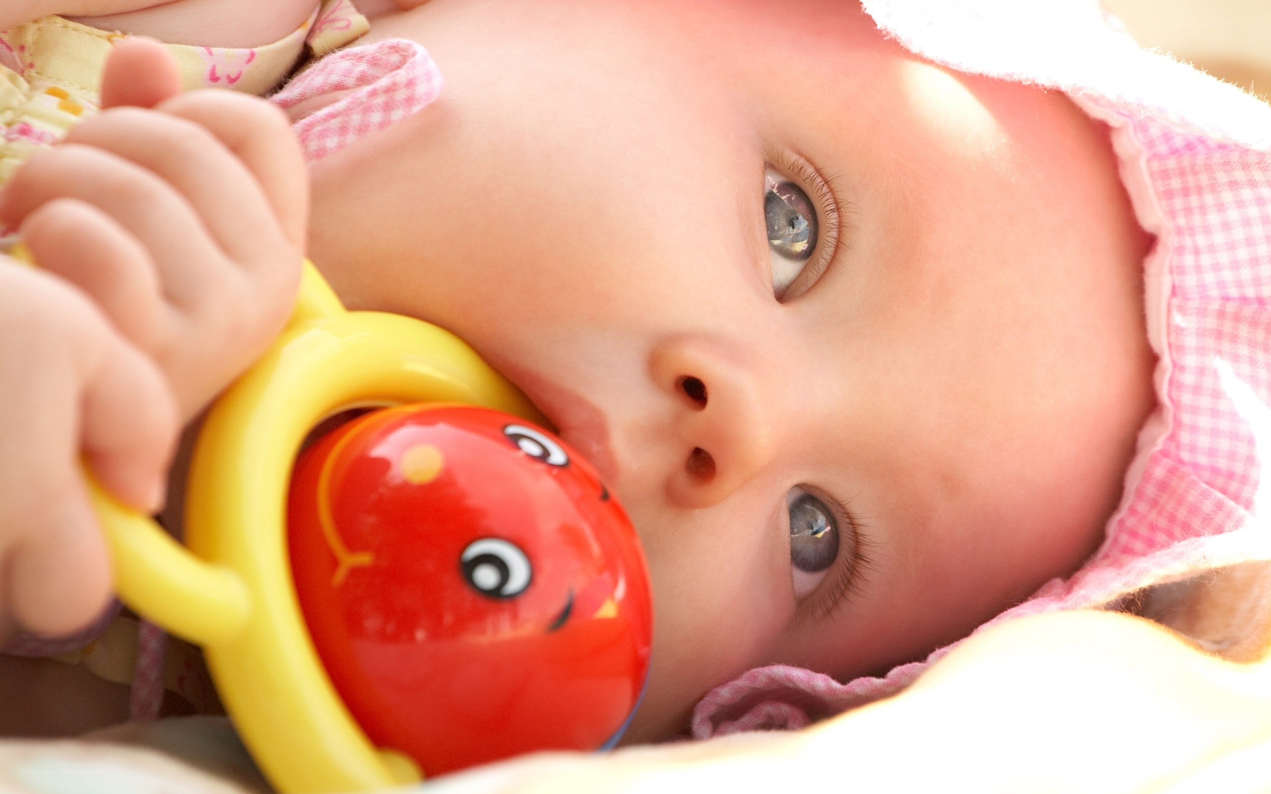 baby with toy in mouth