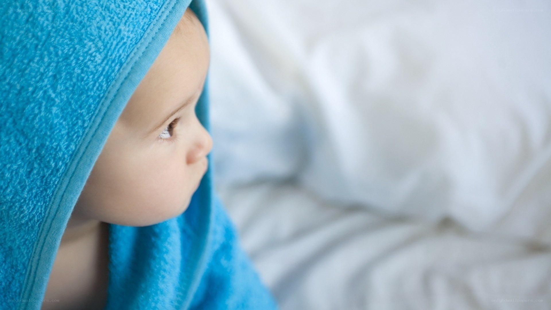 baby wrapped in blue towel
