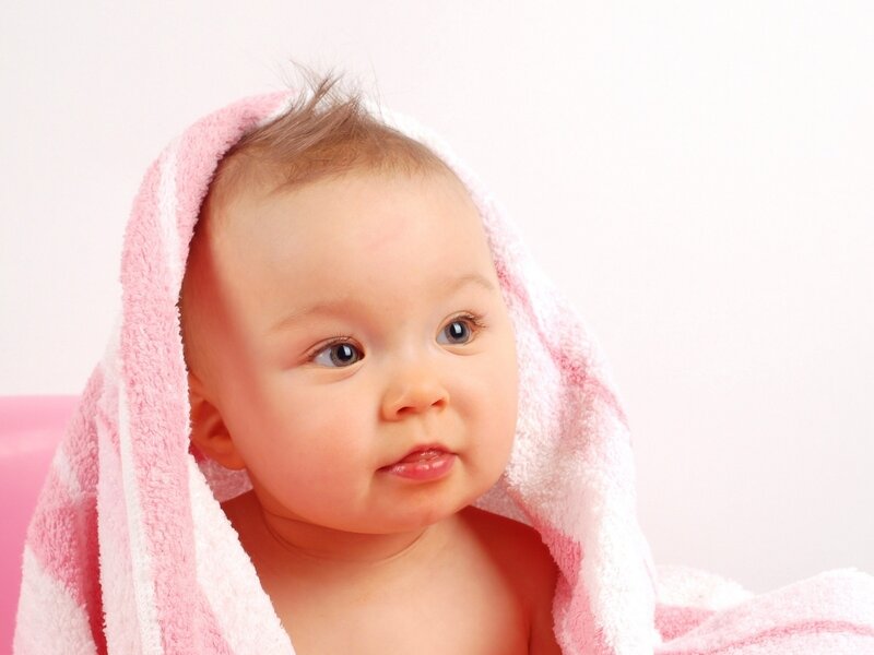 baby wrapped in pink towel
