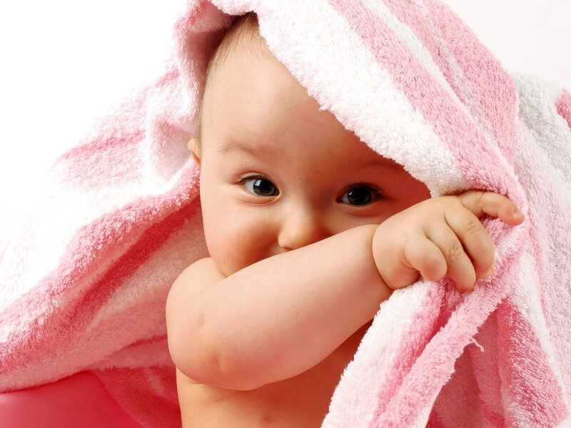 Baby wrapped in pink towel