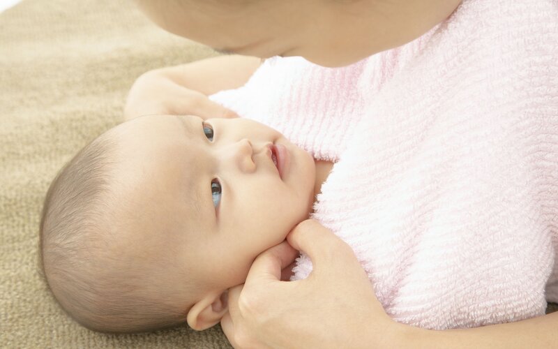 Baby wrapped in pink towel