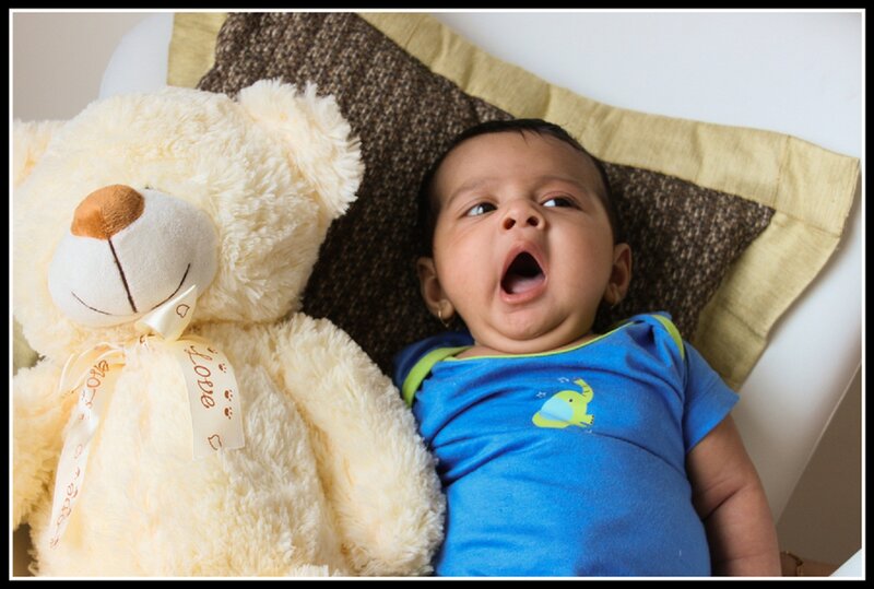 Baby Yawning Next to Teddy Bear