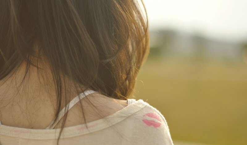 back of girl with lipstick mark