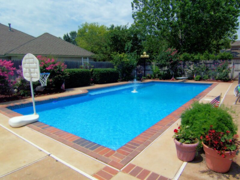 Backyard pool with basketball hoop