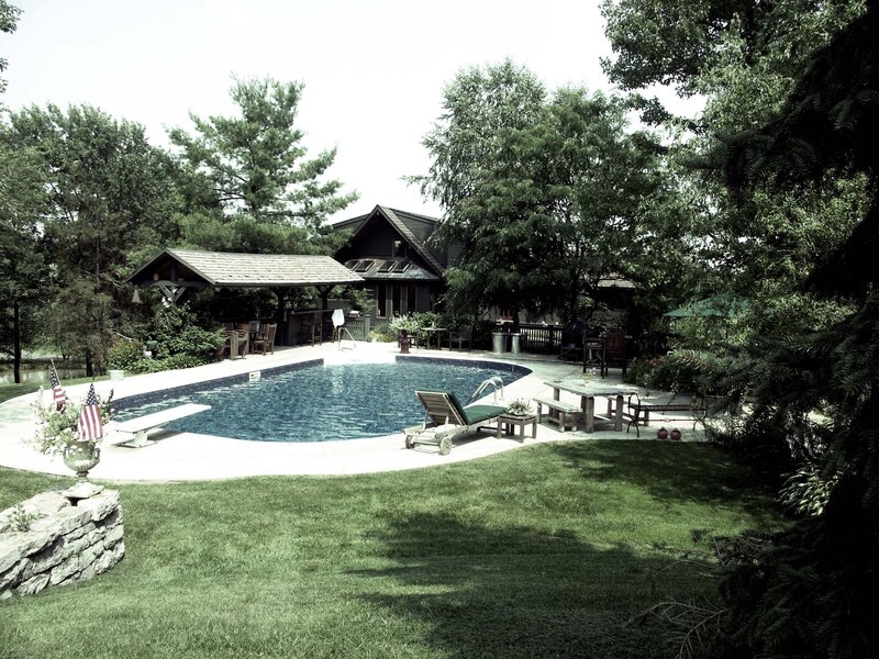 Backyard pool with house and trees