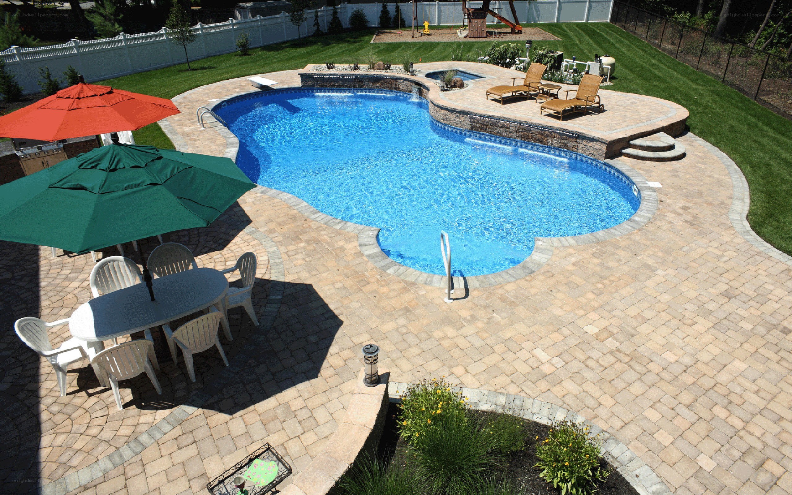 Backyard pool with patio and umbrellas