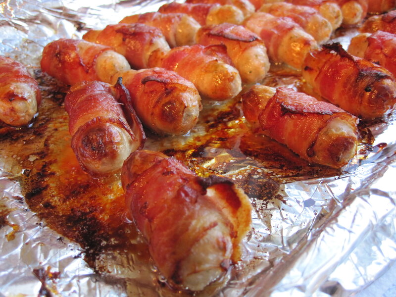 Bacon-wrapped sausages on foil