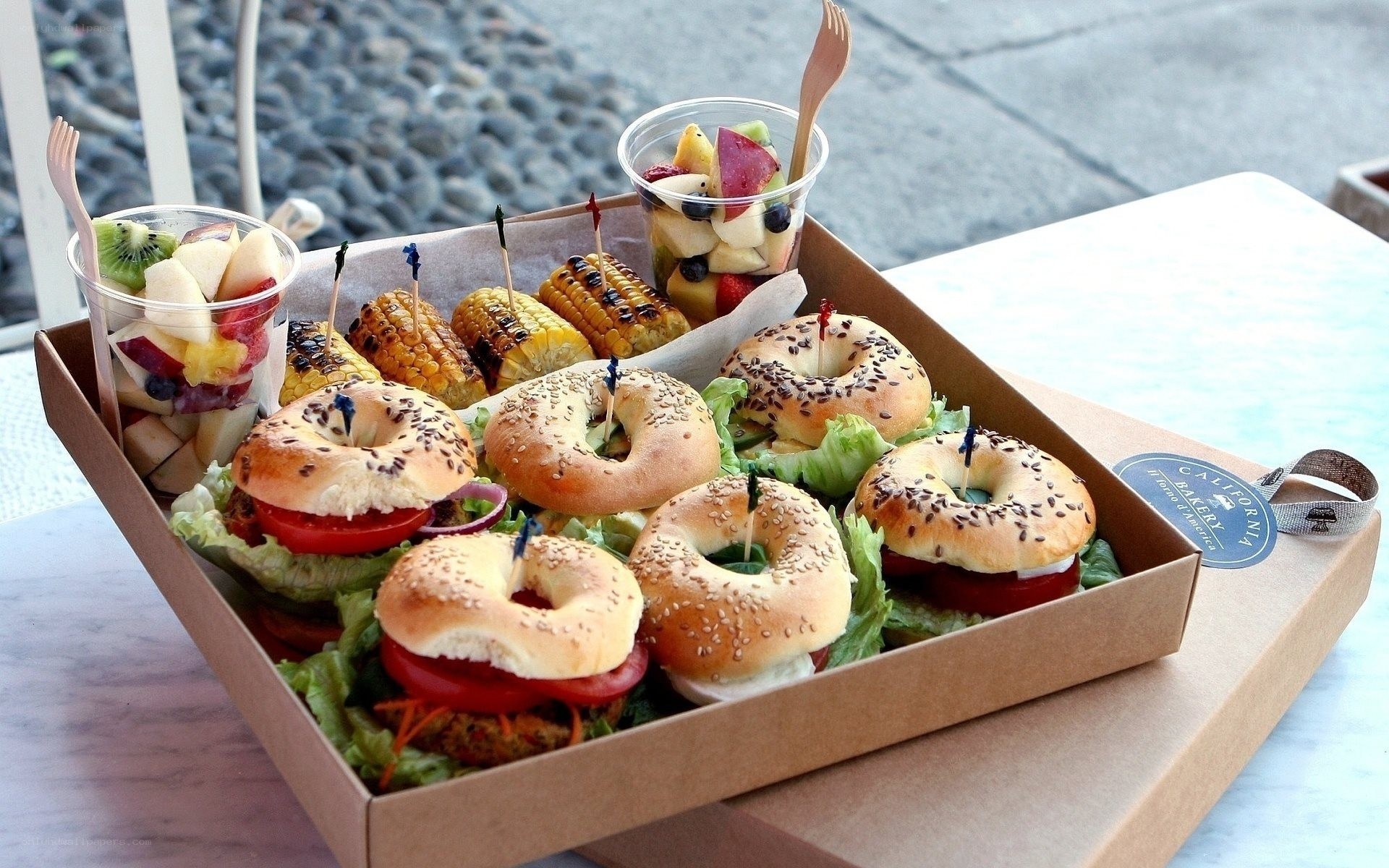 Bagel lunch box with fruit and corn