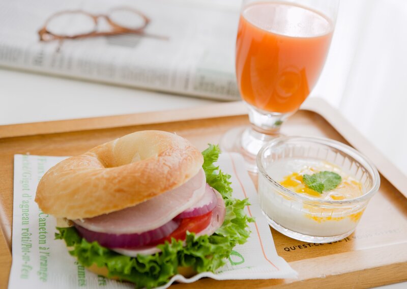 Bagel sandwich with juice and yogurt