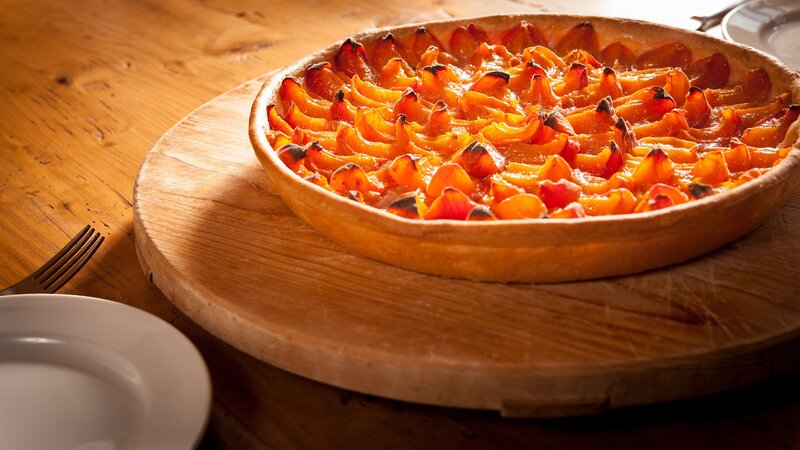 Baked apricot tart on wood
