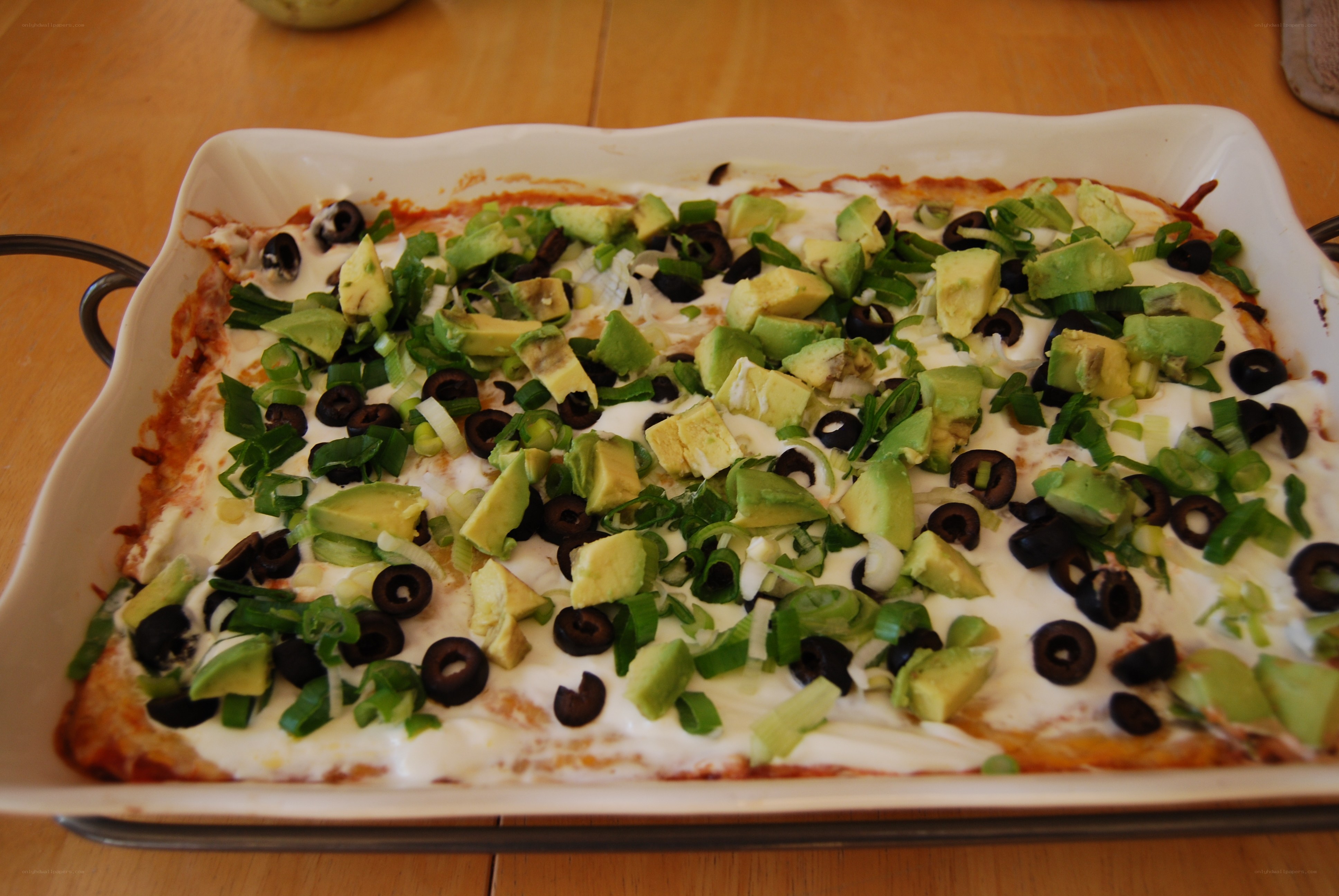 baked dish with avocado and olives