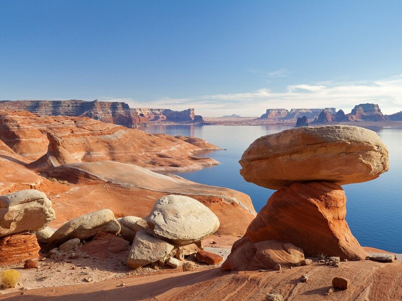 Balanced rock formation by lake