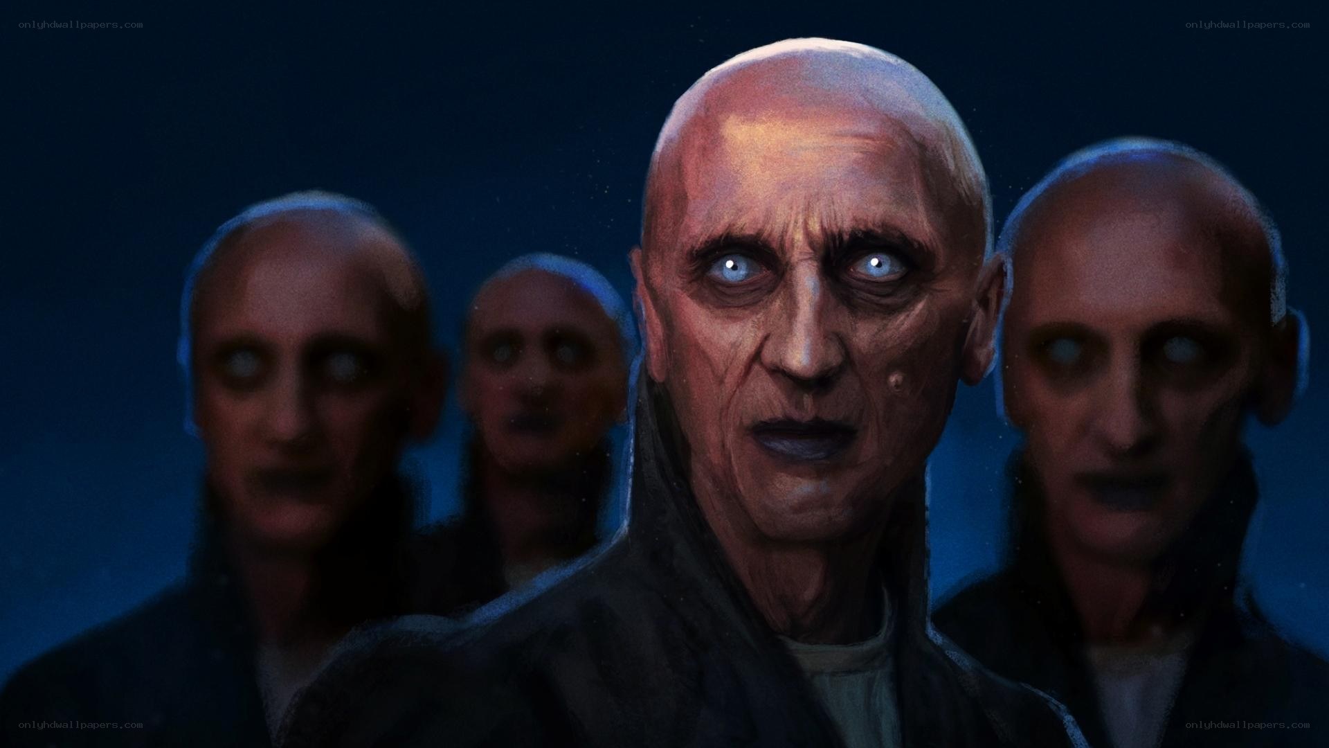 bald figures in dark setting