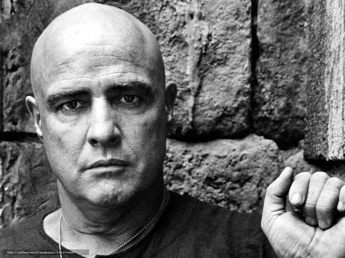 Bald man against stone wall