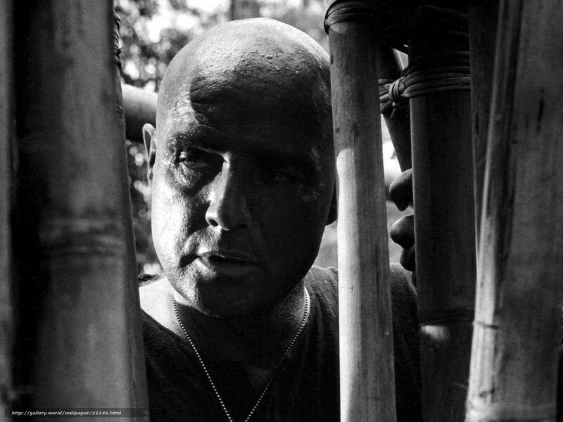 Bald man behind bamboo poles