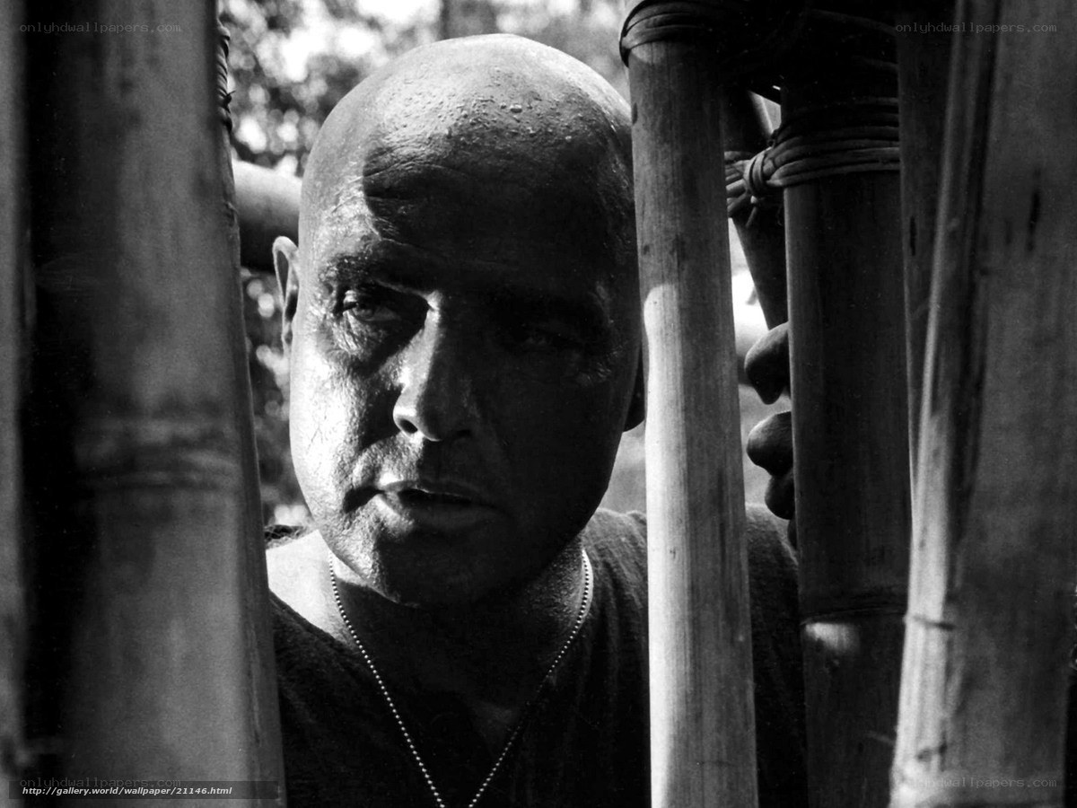 Bald man behind bamboo poles