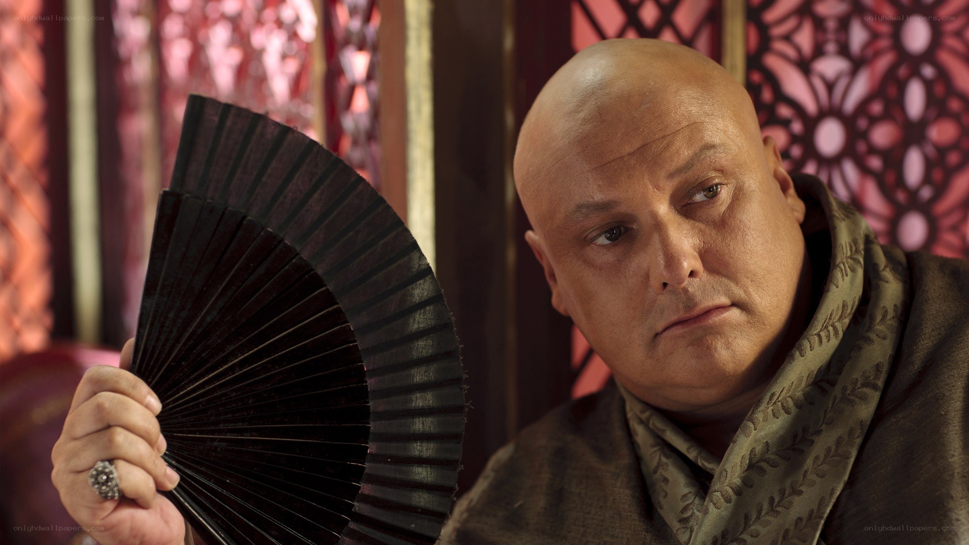 Bald man holding a fan