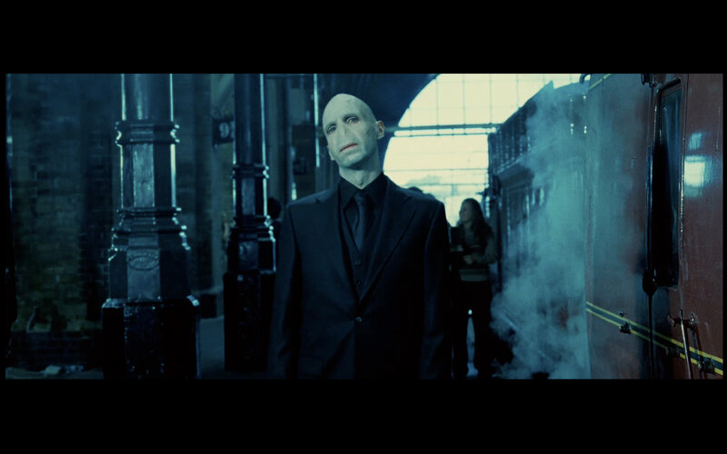 Bald Man in Black Suit — Blue