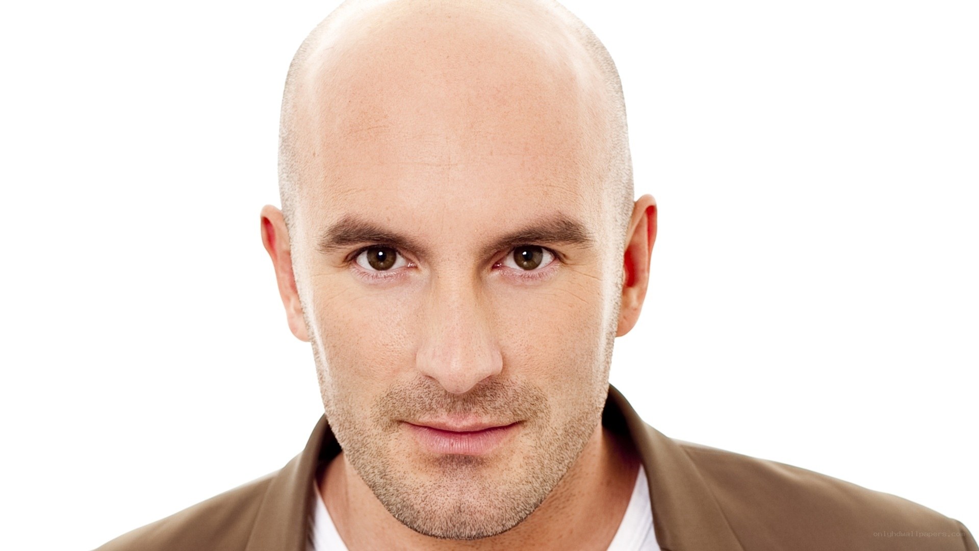 bald man in brown jacket