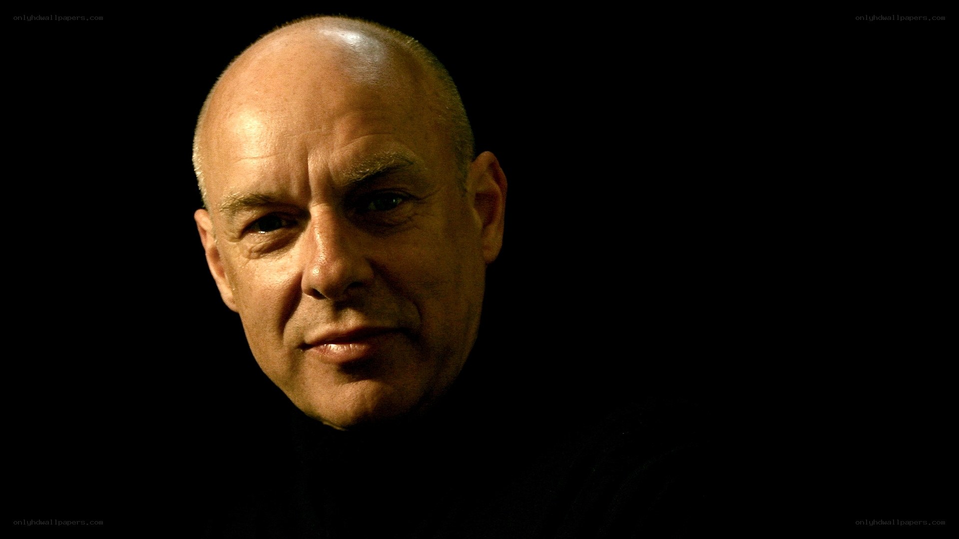 bald man in dark setting